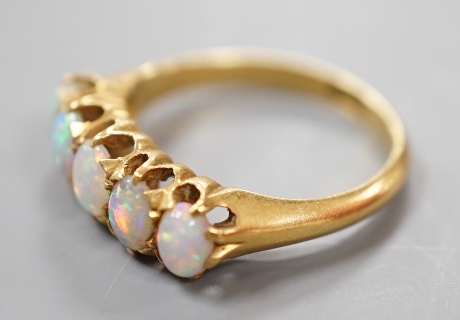 A 18ct and graduated five stone oval white opal set half hoop ring, size L, gross weight 3.8 grams.